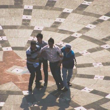 Plainclothes security forces drag away blogger Huynh Ngoc Chenh.