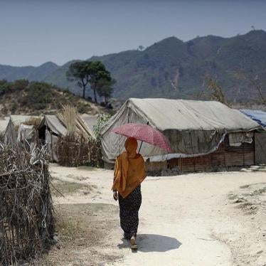 A Rohingya woman walks at an IDP camp in Pauktaw, Arakan State on April 23, 2014.