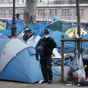 French riot police officer stands guard next to tents of a dismantled makeshift camp in a street near Stalingrad metro station, Paris, France, November 4, 2016. 