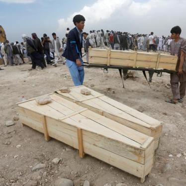 Afghan men carry empty coffins for the victims of a suicide attack in Kabul, Afghanistan July 24, 2016.