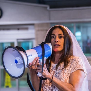 Sonia Ossorio of NOW-NYC addresses the crowd at a protest against US laws allowing child marriage. 