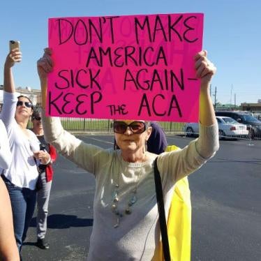 A protester holds a sign at Louisiana Republican Senator Bill Cassidy's town hall meeting in Metairie, Louisiana, February 22, 2017. 