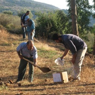 Two men collect the remains of 12-year-old Rami ‘Ali Hassan Shebli, who was killed on October 22, 2006 by a submunition leftover from a cluster munition attack on Halta in Lebanon. Rami unwittingly picked up the submunition while playing with his brother.