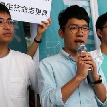 Pro-democracy leaders Nathan Law (C), Joshua Wong (R), and Alex Chow meet journalists outside a court in Hong Kong, on September 21, 2016.