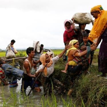 A group of Rohingya refugees cross a canal after travelling over the Bangladesh-Burma border in Teknaf, Bangladesh, September 1, 2017.