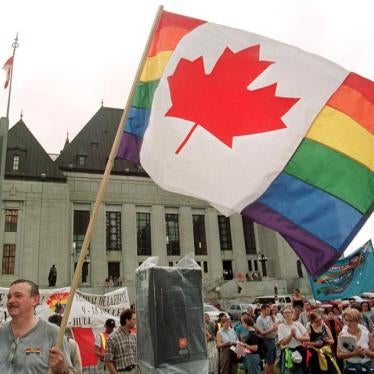 LGBT-rights supporter waves an amalgamation of the Canadian and rainbow flags in front of the Supreme Court of Canada in Ottawa, 1999. In 2017, Canadian government condemned Ramzen Kadyrov’s purge of gay men in Chechnya and announced that nearly 30 victim