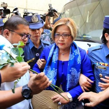 Philippine Senator Leila de Lima, who is detained on drug charges, looks at a flower given by her supporter upon arrival at a local court to face an obstruction of justice complaint in Quezon city, metro Manila, Philippines March 13, 2017.