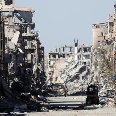 A fighter stands amidst the ruins of buildings near the Clock Square in Raqqa, Syria October 18, 2017. Picture taken October 18, 2017.