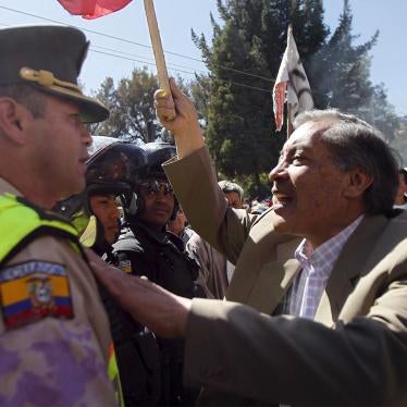 Demonstrators clash with a riot police officer during a protest in Quito, Ecuador, on December 3, 2015, as the Ecuadorean National Assembly attended the second debate about constitutional amendments. 