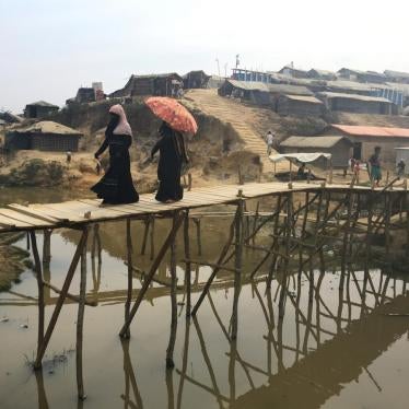 Rohingya refugees walk across a bamboo bridge in the Kutupalong camp in Bangladesh, February 11, 2018.