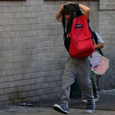 Children cover their faces as they are escorted to the Cayuga Center, which provides foster care and other services to immigrant children separated from their families, in New York City, U.S., July 10, 2018.