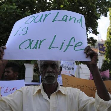  A Sri Lankan Tamil man holds a placard during a protest in Colombo on August 21, 2018, demanding the release of lands still occupied by the military. 