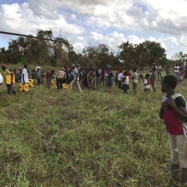 A boy watches the distribution of aid in the remote village of Bopira, Mozambique, April 6, 2019. © 2019 AP Photo/Cara Anna)