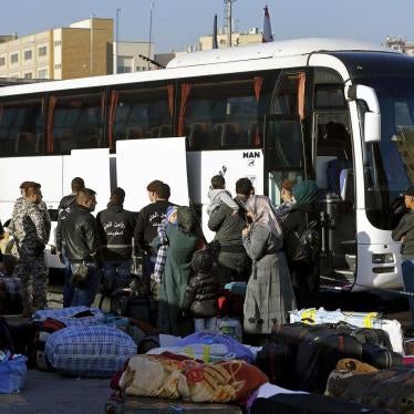 Members of the Lebanese General Security Directorate oversee Syrian refugees boarding a bus to take them home to Syria, in the northern Beirut suburb of Burj Hammoud, Lebanon, Thursday, Jan. 24, 2019. © 2019 AP Photo/Bilal Hussein