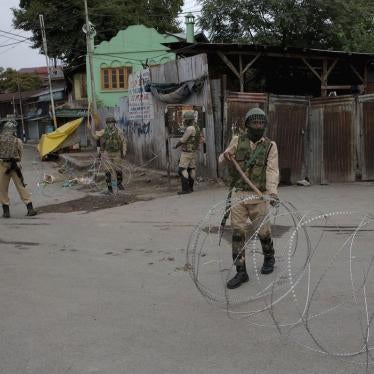 Indian paramilitary soldiers prepares to block a road with barbed wires during security lockdown in Srinagar, Indian controlled Kashmir, Sunday, Aug. 18, 2019. (AP Photo/ Dar Yasin)