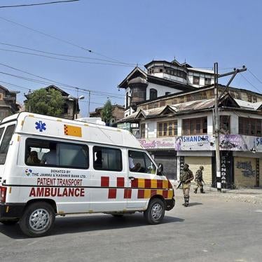 A paramilitary trooper stops an ambulance during the curfew in Srinagar.