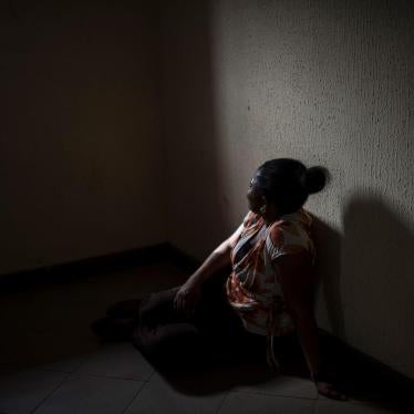 A Nigerian woman sits in a center in Benin City. 