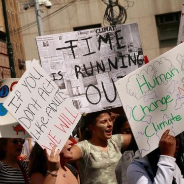 Girls carry signs with environmental slogans on them during a climate strike in New York