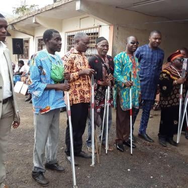 Blind people hold white canes they received from a local organization working with people with disabilities in Buea, South-West region, December 3, 2019.