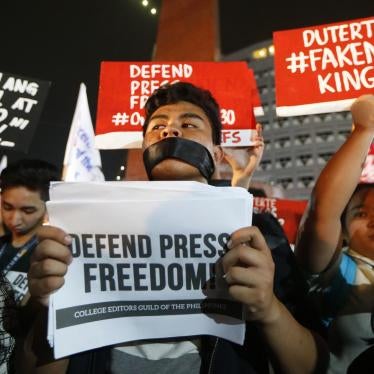 Journalists and supporters, wearing black, display their messages during a protest against the recent Securities and Exchange Commission's revocation of the registration of Rappler, an online news outfit, Friday, Jan. 19, 2018, northeast of Manila, Philip