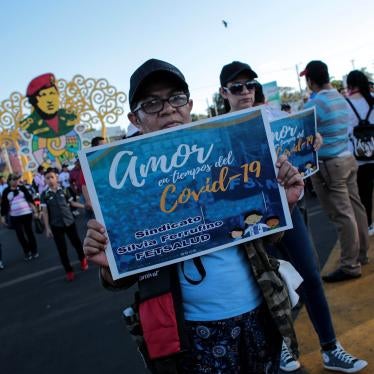 A woman holds a sign that reads "Love in Times of Covid-19" during a government-sponsored march in Managua, Nicaragua, on March 14, 2020.