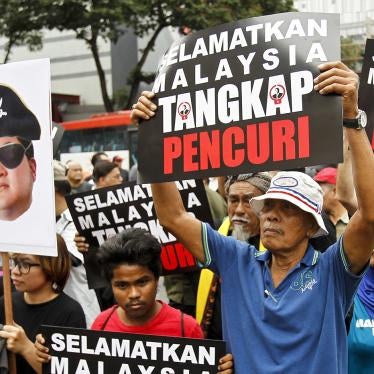 Protesters hold placards reading " Save Malaysia, Arrest the Thief " during a protest in Kuala Lumpur, Malaysia, Saturday, April 14, 2018. 